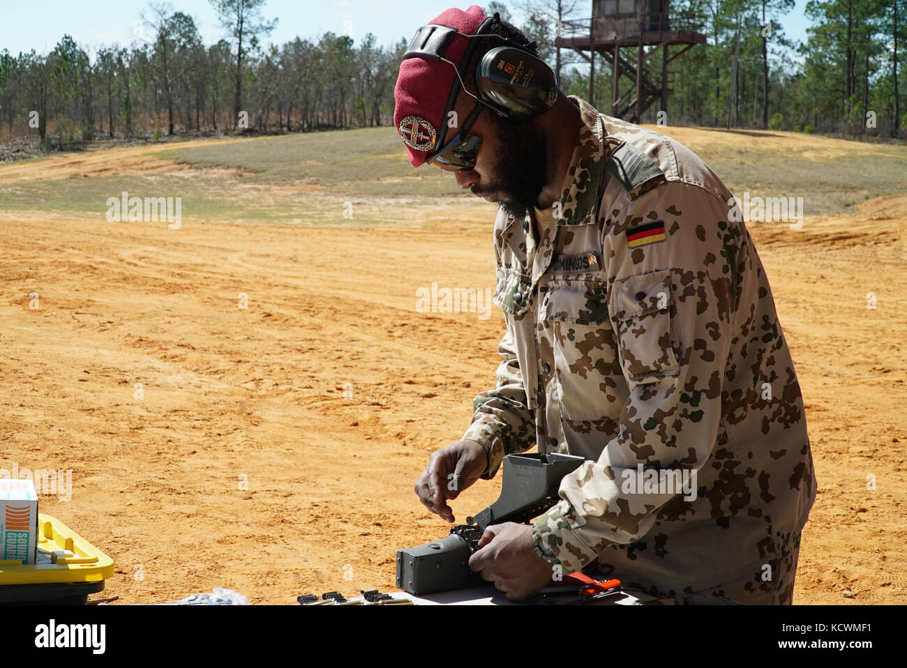 German Armed Forces Spc. Paulo Domingos Manquele loads ammunition for South Carolina National Guard Soldiers and Airmen participating in a live-fire German Proficiency Marksmanship Badge qualification at Fort Jackson, South Carolina with the assistance of Soldiers from the German Armed Forces Command, Mar. 8, 2017. The South Carolina National Guard service members utilized the German MG 3 machine gun, P8 pistol, and G36 assault rifle during the event. (U.S. Army National Guard photo by Capt. Brian Hare) Stock Photo