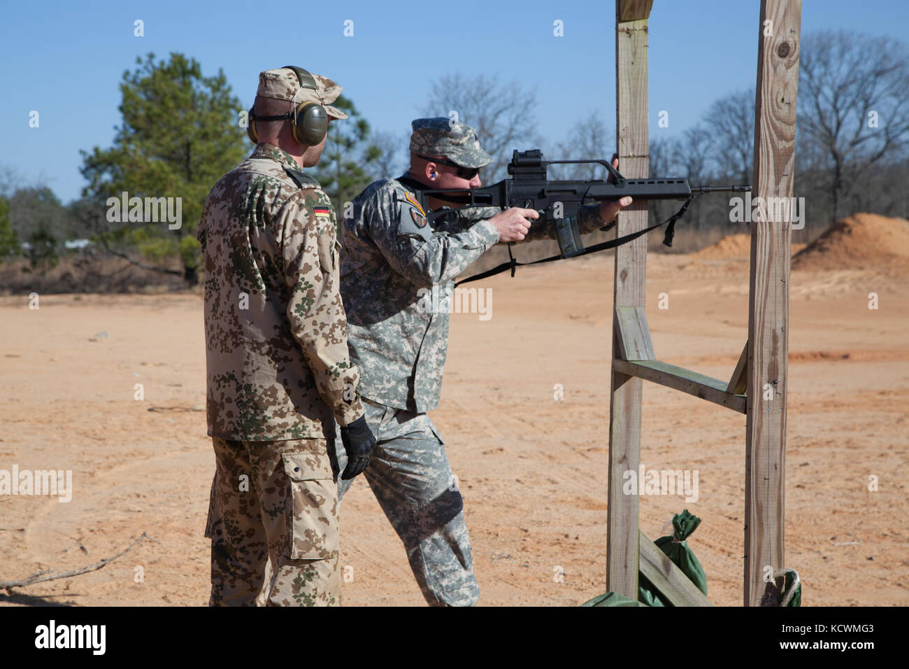 German Armed Forces Spc. Kai Feyand observes U.S. Army Sgt. Christopher Barefoot as South Carolina National Guard Soldiers and Airmen participate in a live-fire German Proficiency Marksmanship Badge qualification at Fort Jackson, South Carolina with the assistance of Soldiers from the German Armed Forces Command, Mar. 9, 2017. The South Carolina National Guard service members utilized the German MG 3 machine gun, P8 pistol, and G36 assault rifle during the event. (U.S. Army National Guard photo by Capt. Brian Hare) Stock Photo