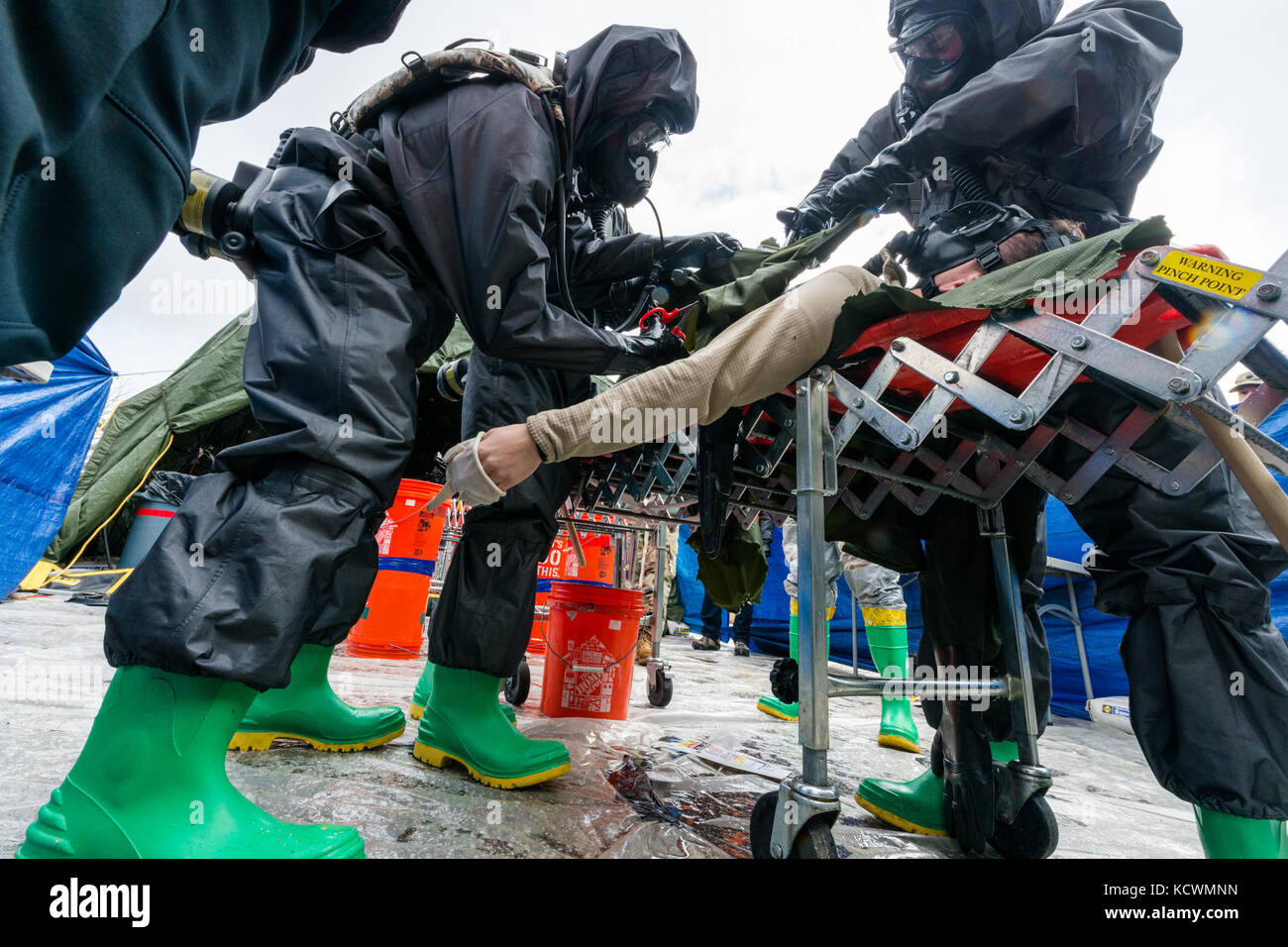 U.S. Army Pfc. Samuel Sides, medic assigned to the 251st Area Support Medical Company, South Carolina Army National Guard, is decontaminated and triaged after becoming non responsive during a joint training exercise at Rosewood Center, Owings Mills, Maryland, March 10, 2017.  The 251st along with the 231st Chemical Company from the Maryland Army National Guard are participating in an U.S. Army North validation exercise where they will be setting up a full medical area and completing triage at the casualty collection point. (U.S. Air National Guard photo by Tech. Sgt. Jorge Intriago) Stock Photo