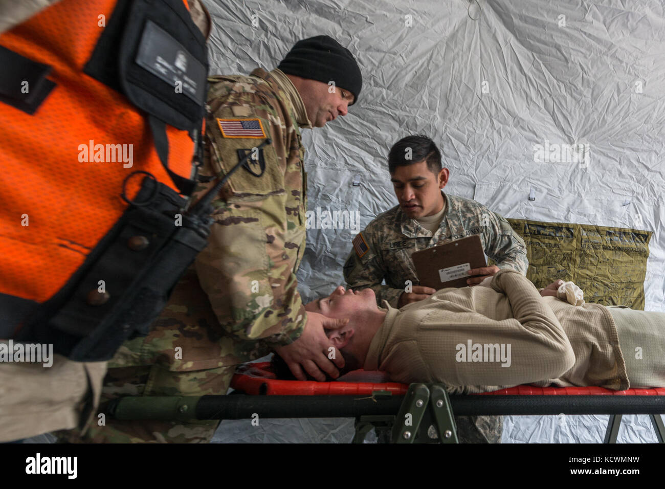 U.S. Army Pfc. Samuel Sides, medic assigned to the 251st Area Support Medical Company, South Carolina Army National Guard, is decontaminated and triaged after becoming non responsive during a joint training exercise at Rosewood Center, Owings Mills, Maryland, March 10, 2017.  The 251st along with the 231st Chemical Company from the Maryland Army National Guard are participating in an U.S. Army North validation exercise where they will be setting up a full medical area and completing triage at the casualty collection point. (U.S. Air National Guard photo by Tech. Sgt. Jorge Intriago) Stock Photo