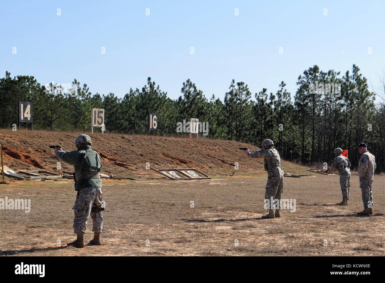 Military members participate in the annual South Carolina National Guard TAG match during the M9 pistol marksmanship portion at a firing range near the McCrady Training Center, Eastover, South Carolina, March 6, 2016.  More than 50 participants joined the TAG match competition held March 5-6, hosted by the South Carolina Army National Guard's Marksmanship Training Unit and included teams from the S.C. Air National Guard, Fort Jackson, and a team from Germany. (U.S. Army National Guard photo by Lt. Col. Cindi King/ released) Stock Photo