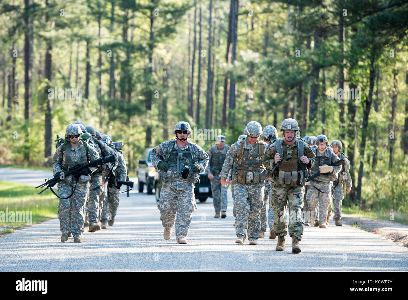 U.S. Soldiers assigned to the Florida Army National Guard conduct a 12 mile ruck march with 218th Regiment (Leadership), South Carolina Army National Guard 12 Bravo Combat Engineer instructors at McCrady Training Center, in Eastover, S.C. April 4, 2016. The ruck march is part of the combat engineer military occupation specialty retraining for soldiers transitioning to the 12 bravo career field, this class was the first to train women going into the career field at McCrady. (U.S. Air National Guard photo by Tech. Sgt. Jorge Intriago) Stock Photo