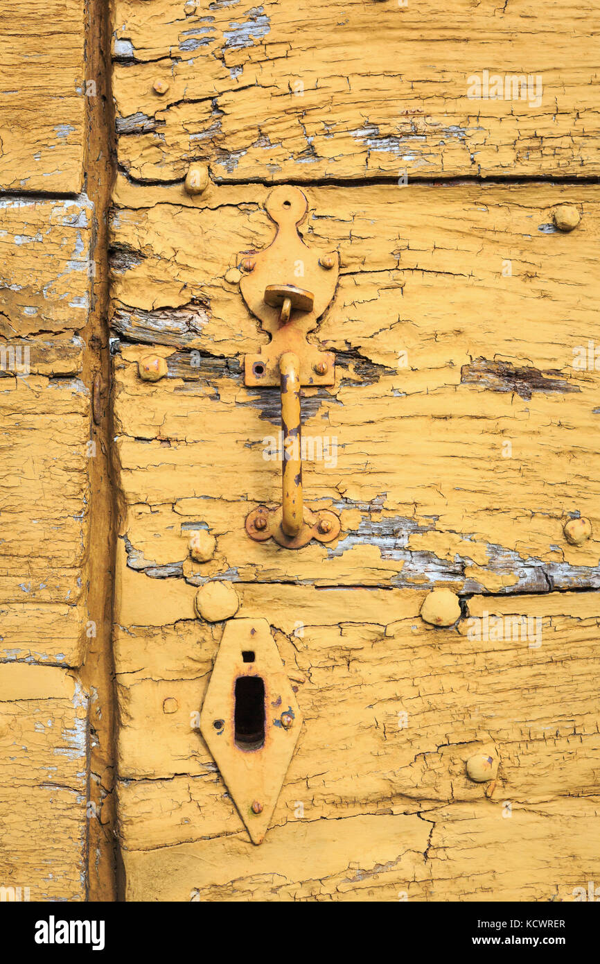 SAINT-LEONARD-DE-NOBLAT, FRANCE - 22 JULY, 2017: Detail of old and distressed wooden planks, with weathered yellow paint. Stock Photo