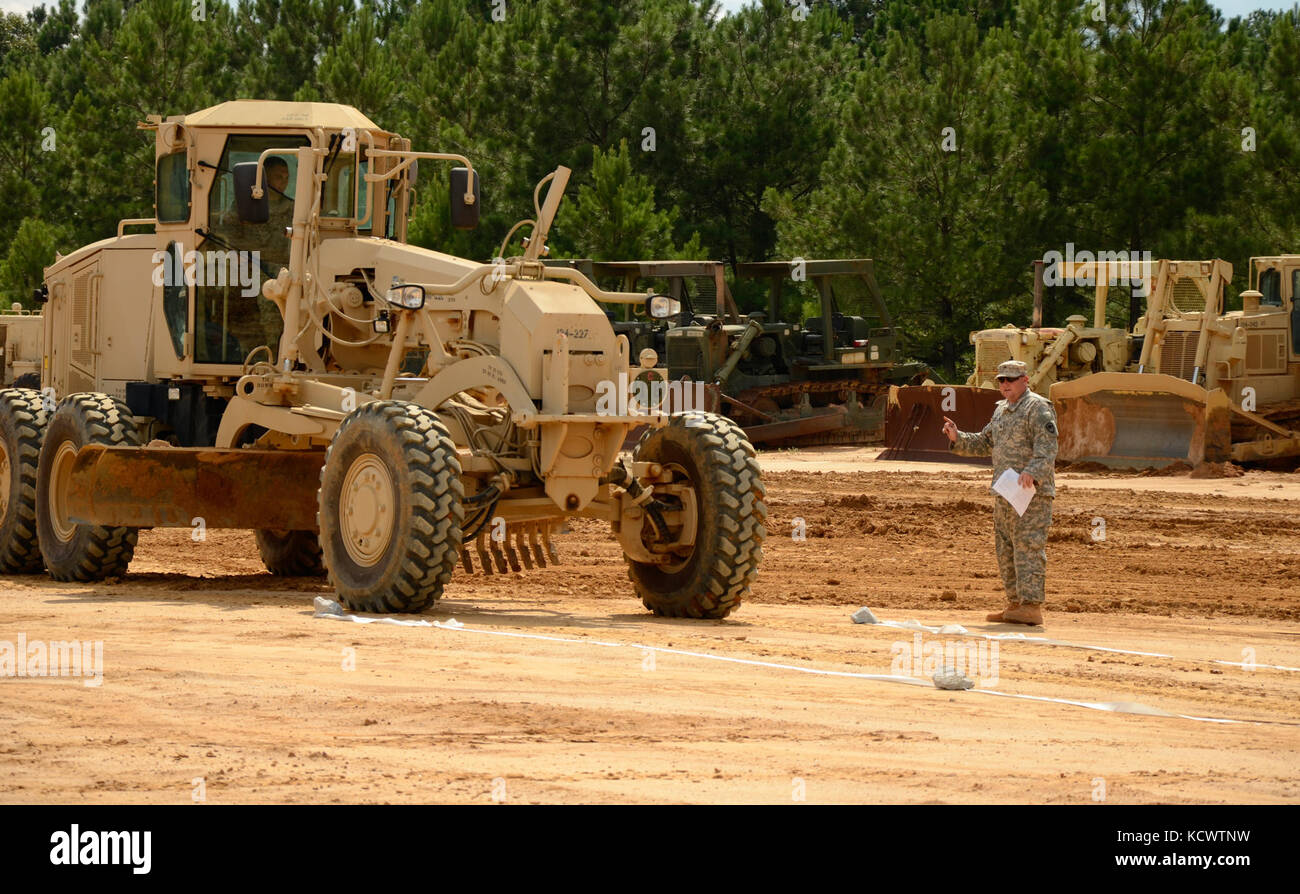 South Carolina National Guard Soldiers from the 124th Engineer Company, 172nd Engineer Platoon and the 1782nd Engineer Company competed in the Best Engineer Competition at the McCrady Training Center Aug. 5, 2016. As one of the horizontal engineer tasks, each Soldier had to operate a motor grader in a confined space by maneuvering the vehicle without knocking a softball off the top of a cone. This is the second year of the combined competition between the 178th and 122nd Engineer Battalions. (U.S. Army photo by 1st Lt. Jessica Donnelly, 108th Public Affairs Detachment) Stock Photo