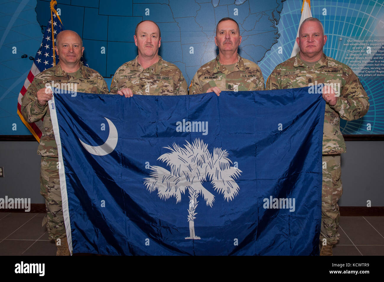 (L-R) U.S. Army Maj. Gen. Robert E. Livingston, Jr., the adjutant general for South Carolina, U.S. Army Col. James D. Peake, Task Force Swamp Fox commander, U.S. Army Command Sgt. Maj. Jamie Wilbanks, Task Force Swamp Fox command sergeant major, and Command Sgt. Maj. Russ Vickery, South Carolina National Guard state command sergeant major, hold the flag for the state of South Carolina at the Joint Air Defense Operations Center on Joint Base Anacostia-Bolling in the District of Columbia, Dec. 21, 2016.  Livingston  presented the flag, which was recently flown over the South Carolina state capit Stock Photo