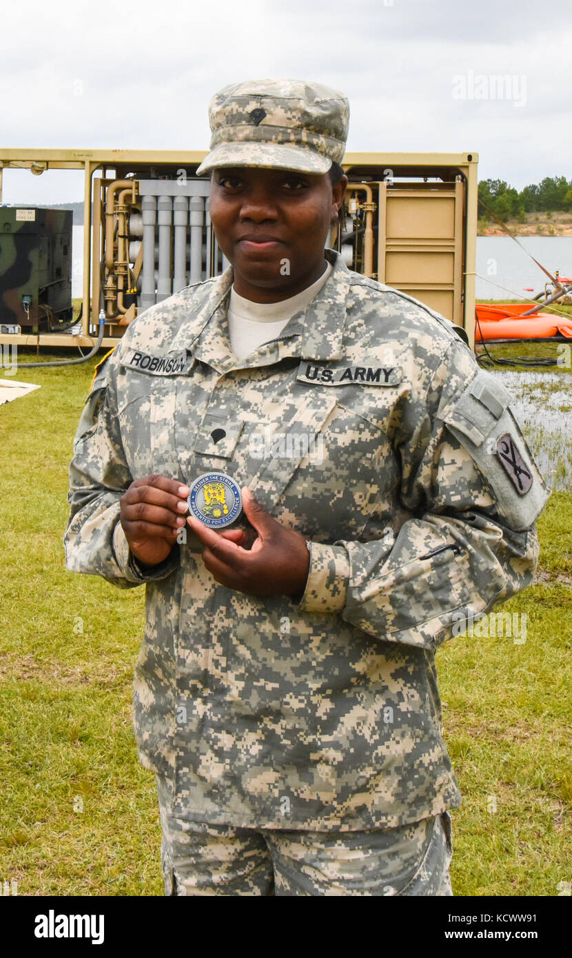U.S. Army Spc. Courtney Robinson, Alpha Co., 218th BSB, South Carolina National Guard, is presented with a coin from Lt. Col. Robert Lowe, 348th BSB battalion commander, Georgia National Guard, for her hard work during Vigilant Guard 17 at the Amerson Water Treatment Plant in Macon, Georgia, March 28. Vigilant Guard 17 is a Joint Regional Training Exercise providing the South Carolina National Guard an opportunity to improve cooperation and relationships with local, state regional civilian, military and federal partners in preparation for emergencies and catastrophic events.  (U.S. Army Nation Stock Photo