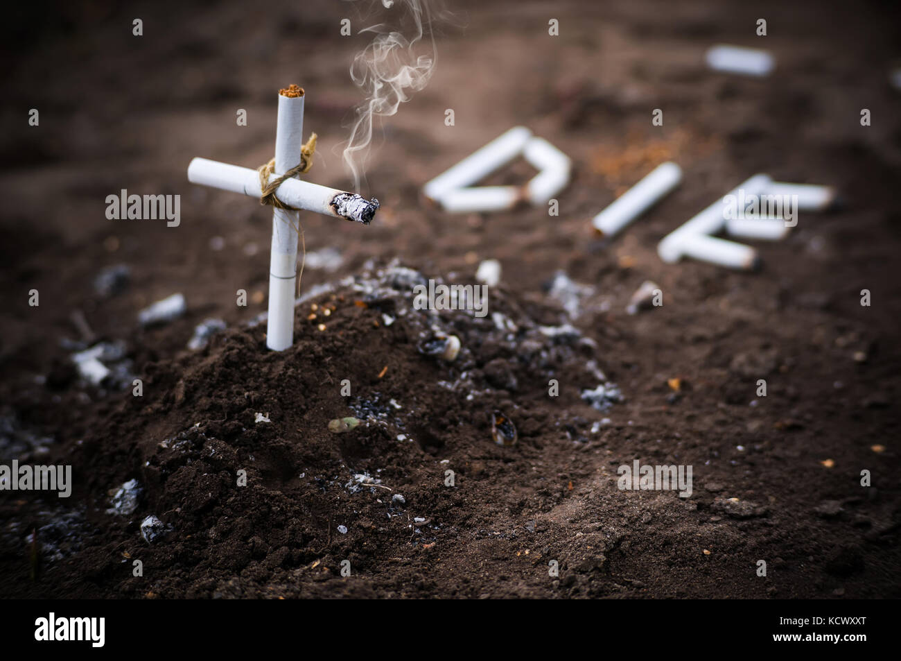 a cross from butts. Smoking kills. word die laid out the cigarettes on