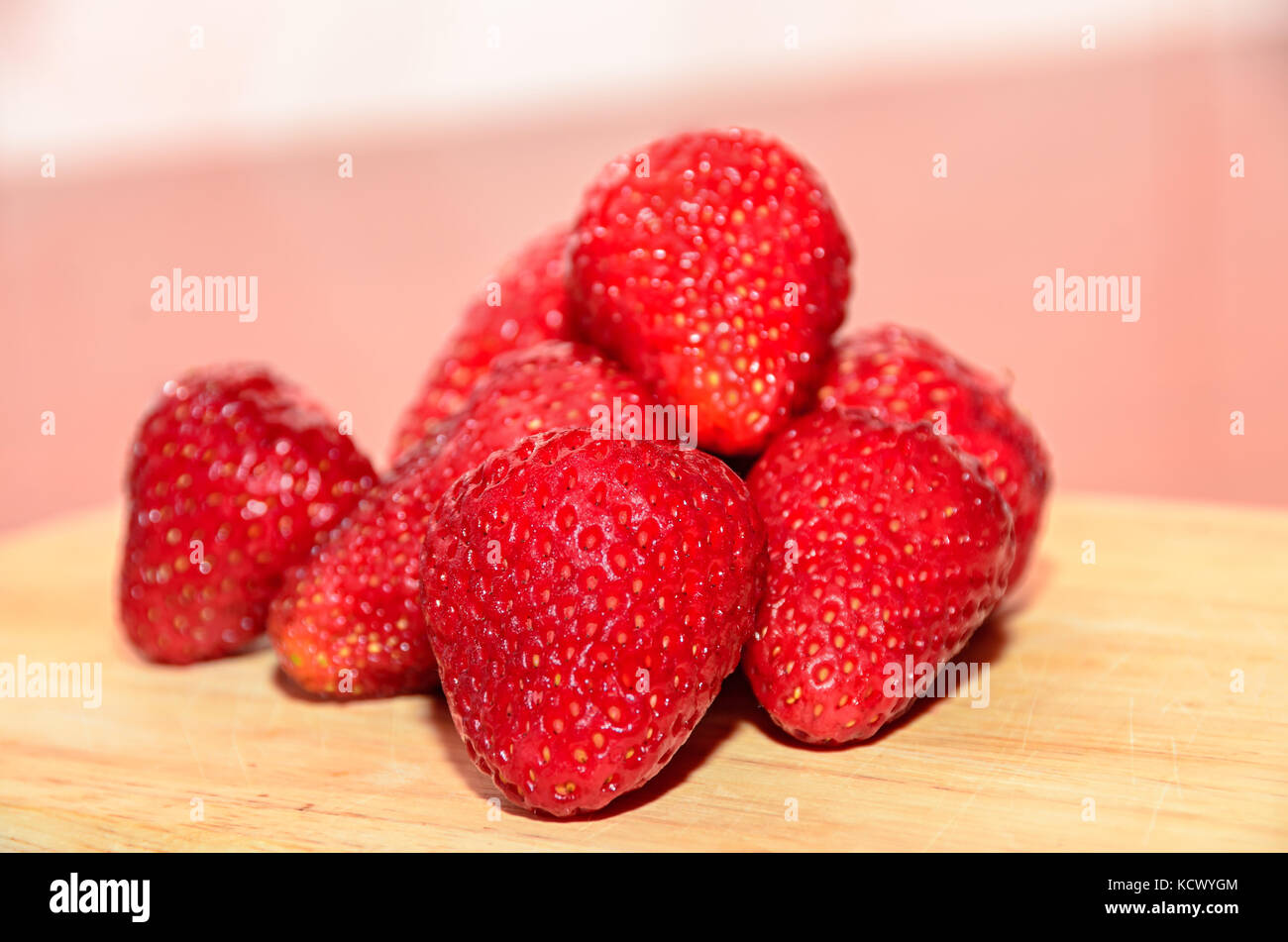Red strawberries fruits, rustic wood background, close up Stock Photo ...