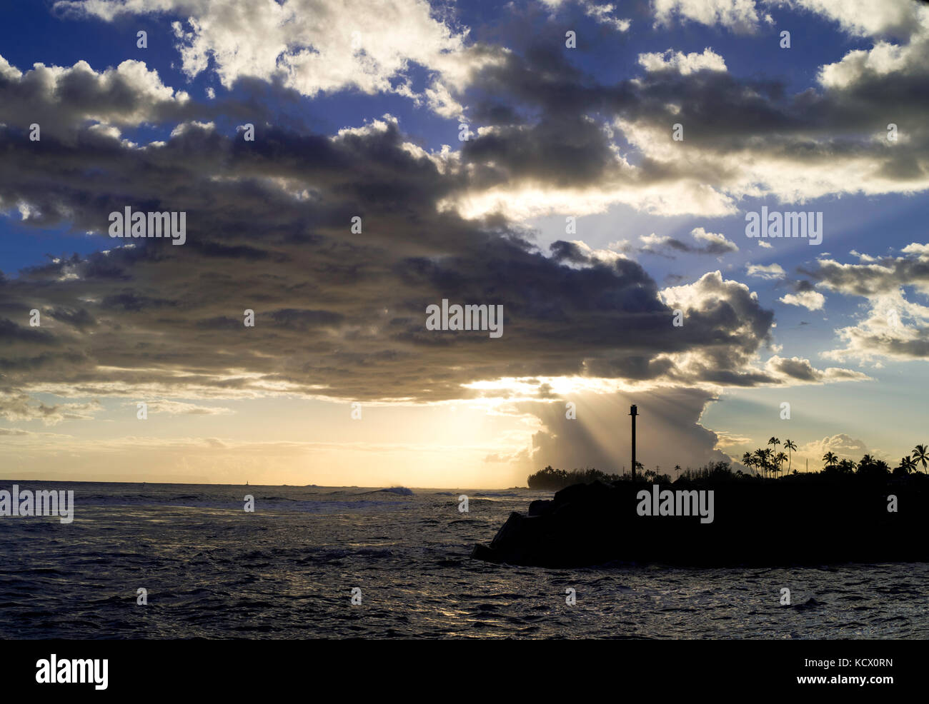 Sunset through the clouds at Kekaha Harbor, on the southwest side of