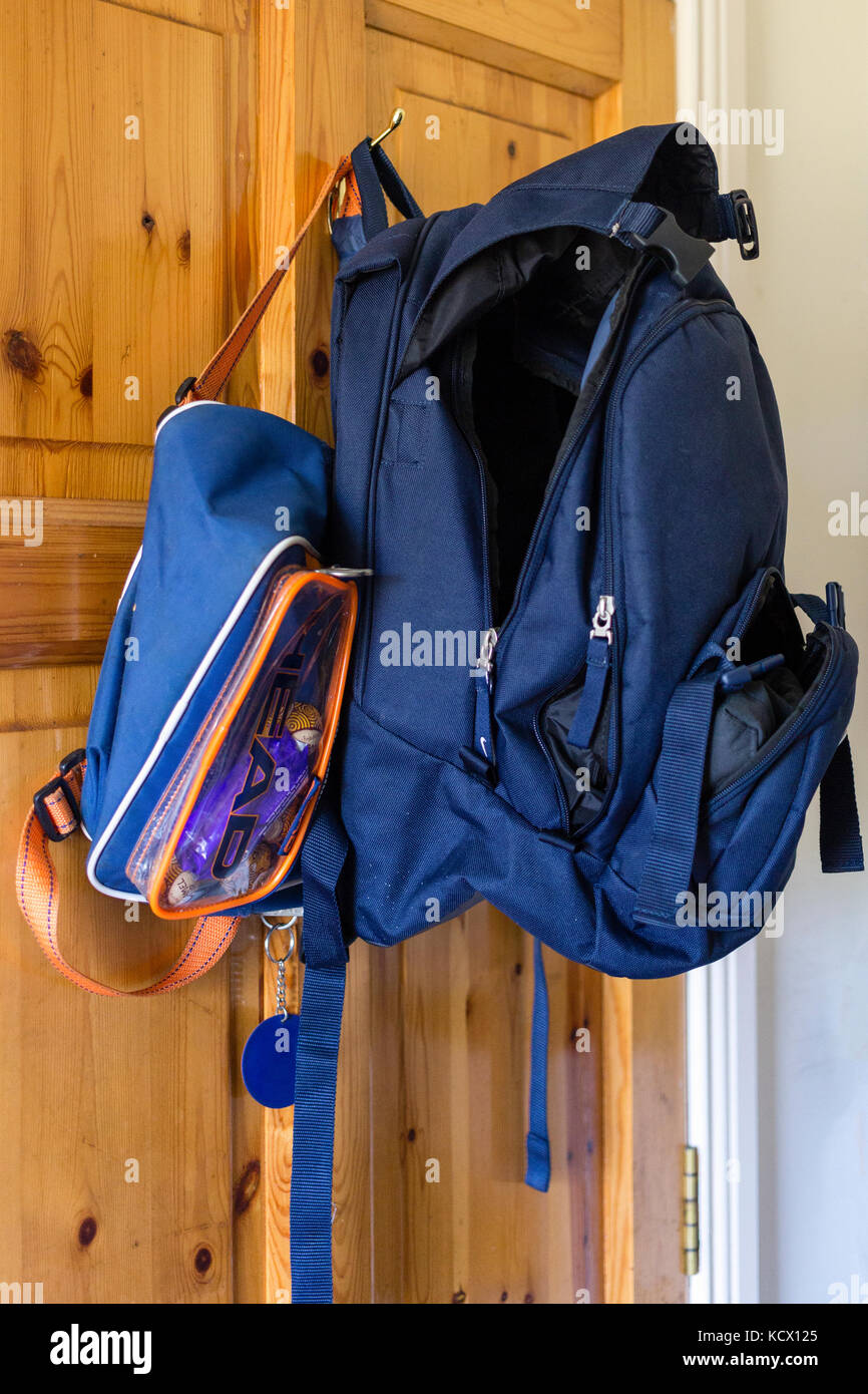 Backpacks and satchel handing on a door Stock Photo