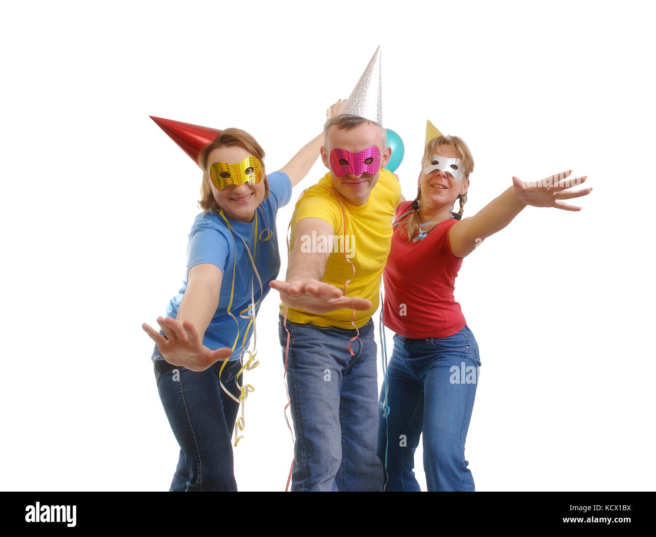 Group of friends having fun at party wearing paper cone caps and masks - isolated on white Stock Photo