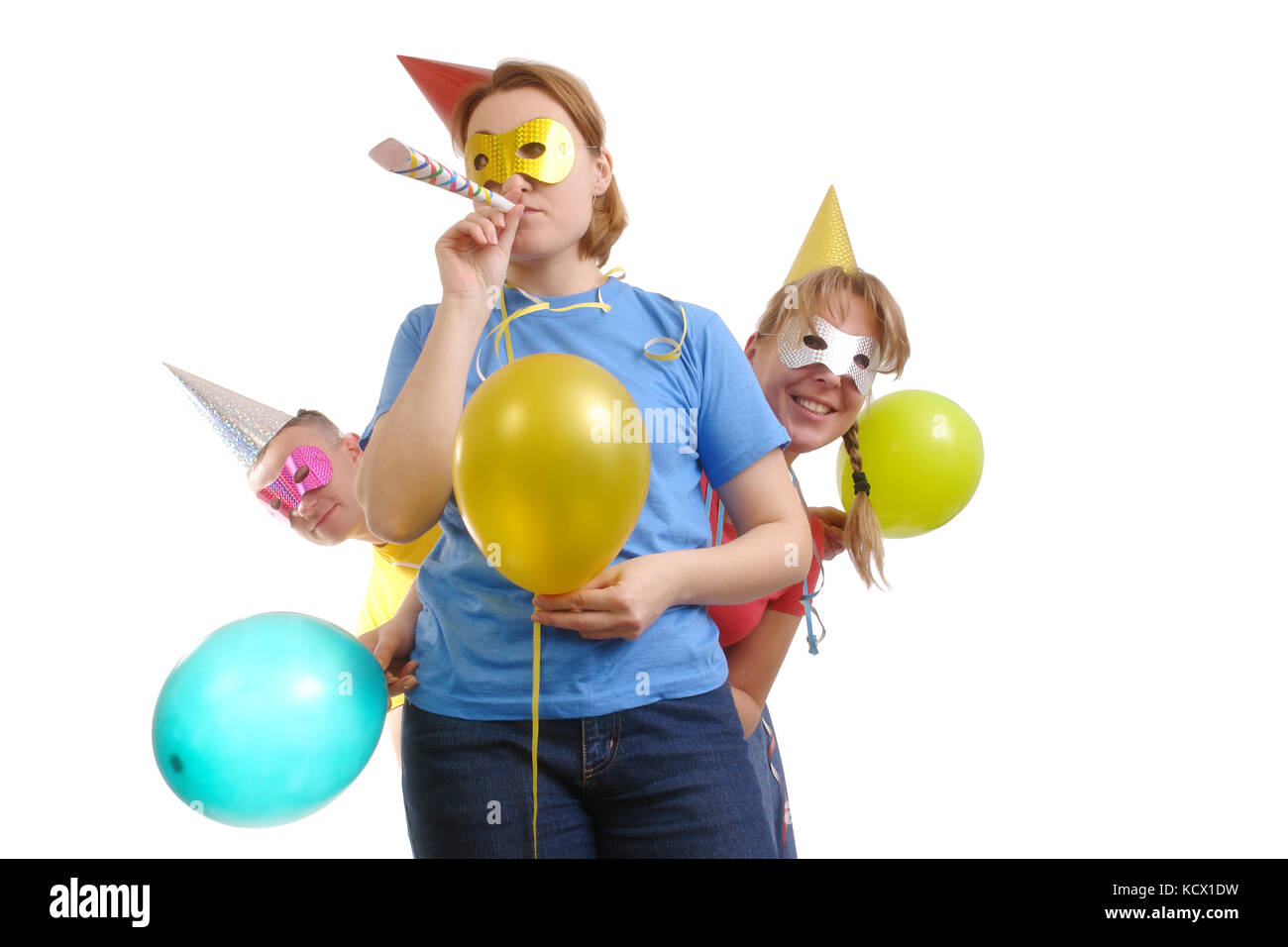 Group of friends having good time at party wearing paper cone caps and masks - isolated on white Stock Photo