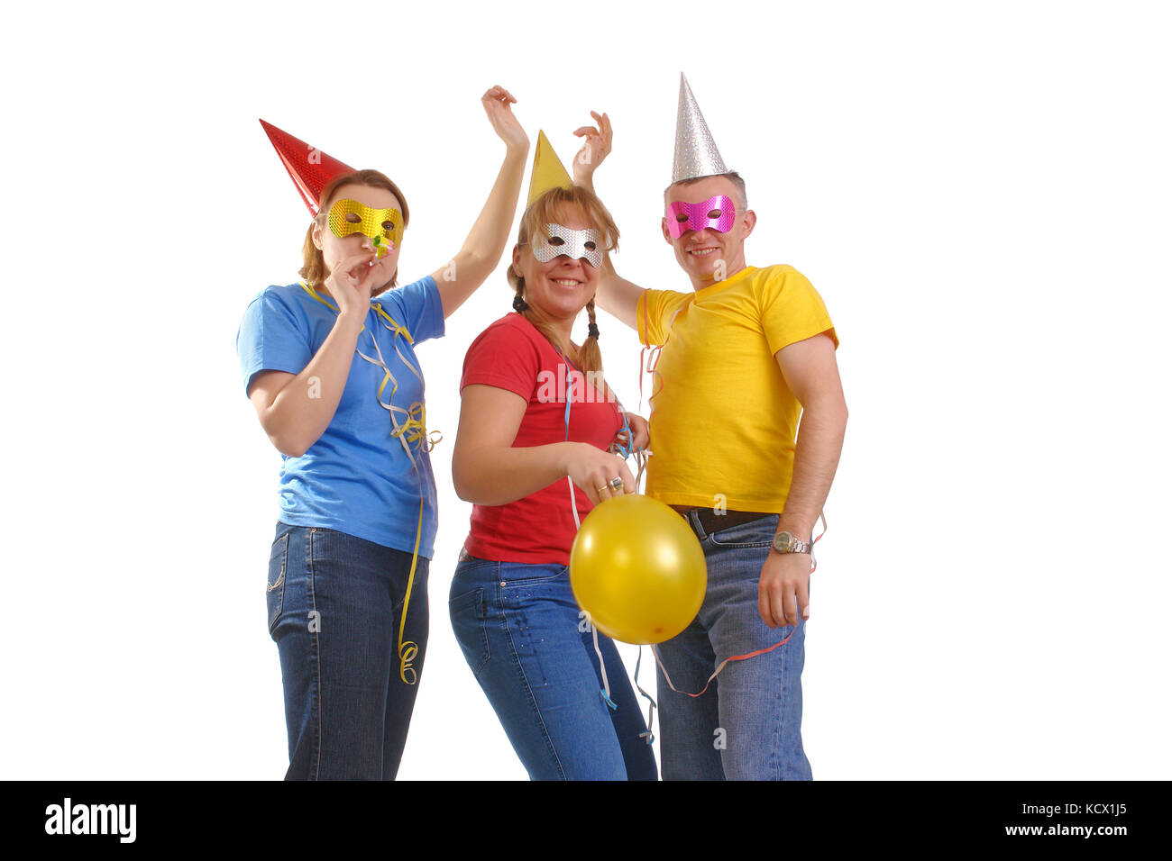 Group of friends wearing party masks and hats posing over white Stock Photo