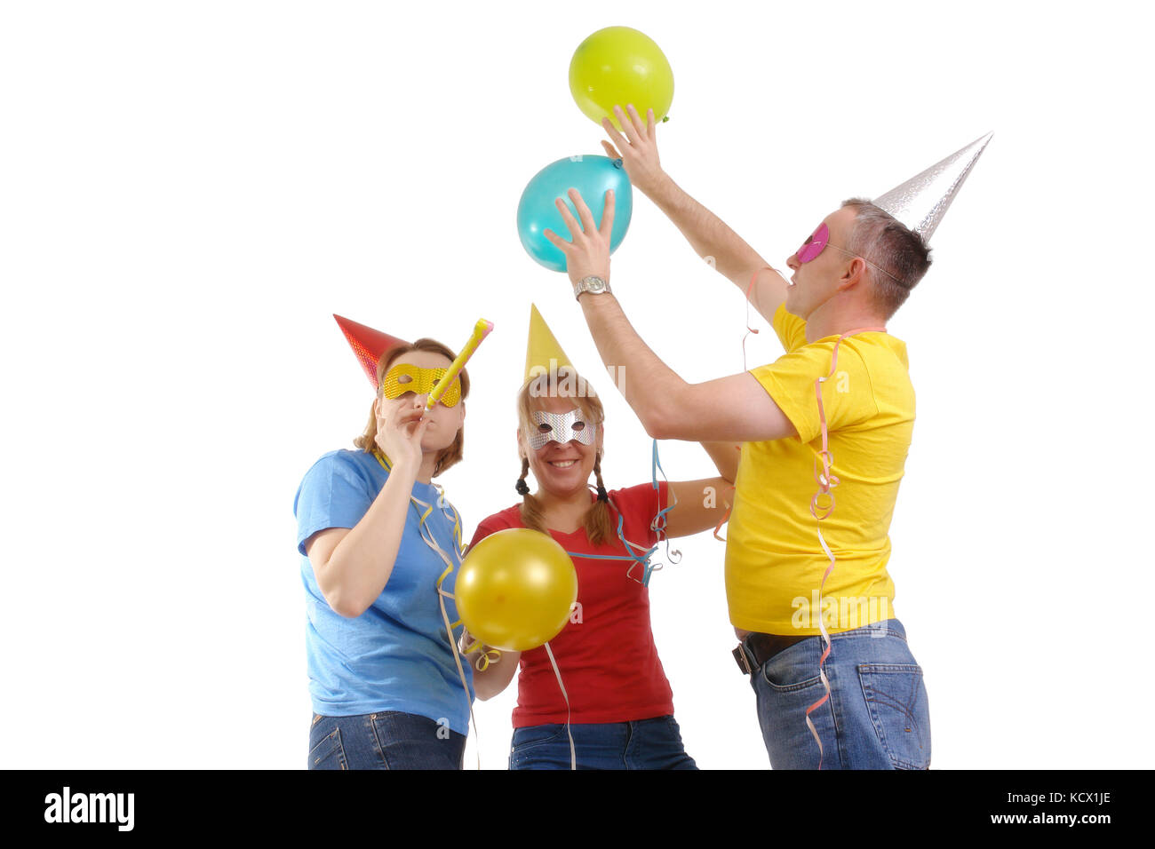 Group of friends wearing party masks and hats having fun over white Stock Photo
