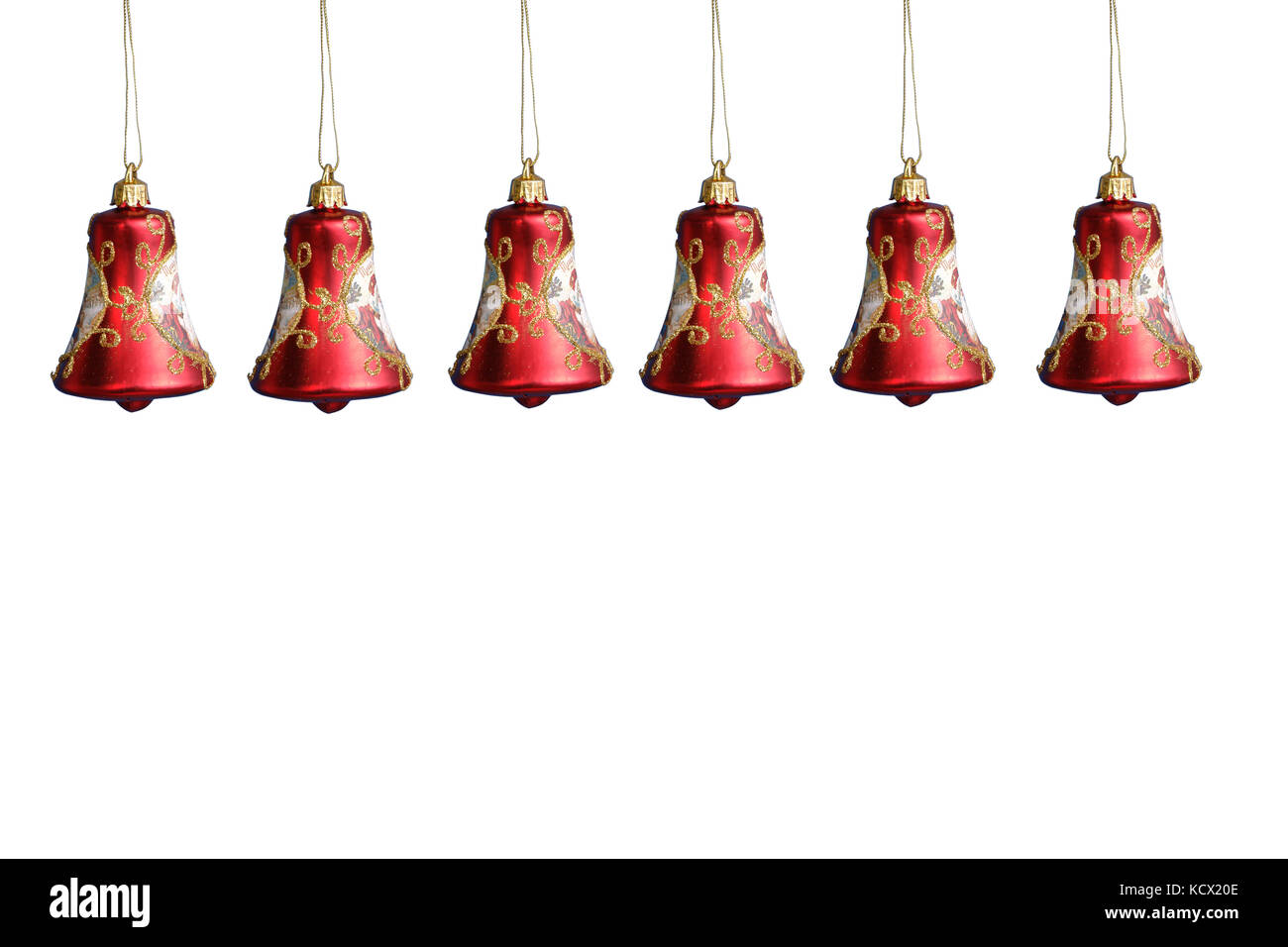 Row of red christmas bell decorations hanging on strings over white background Stock Photo