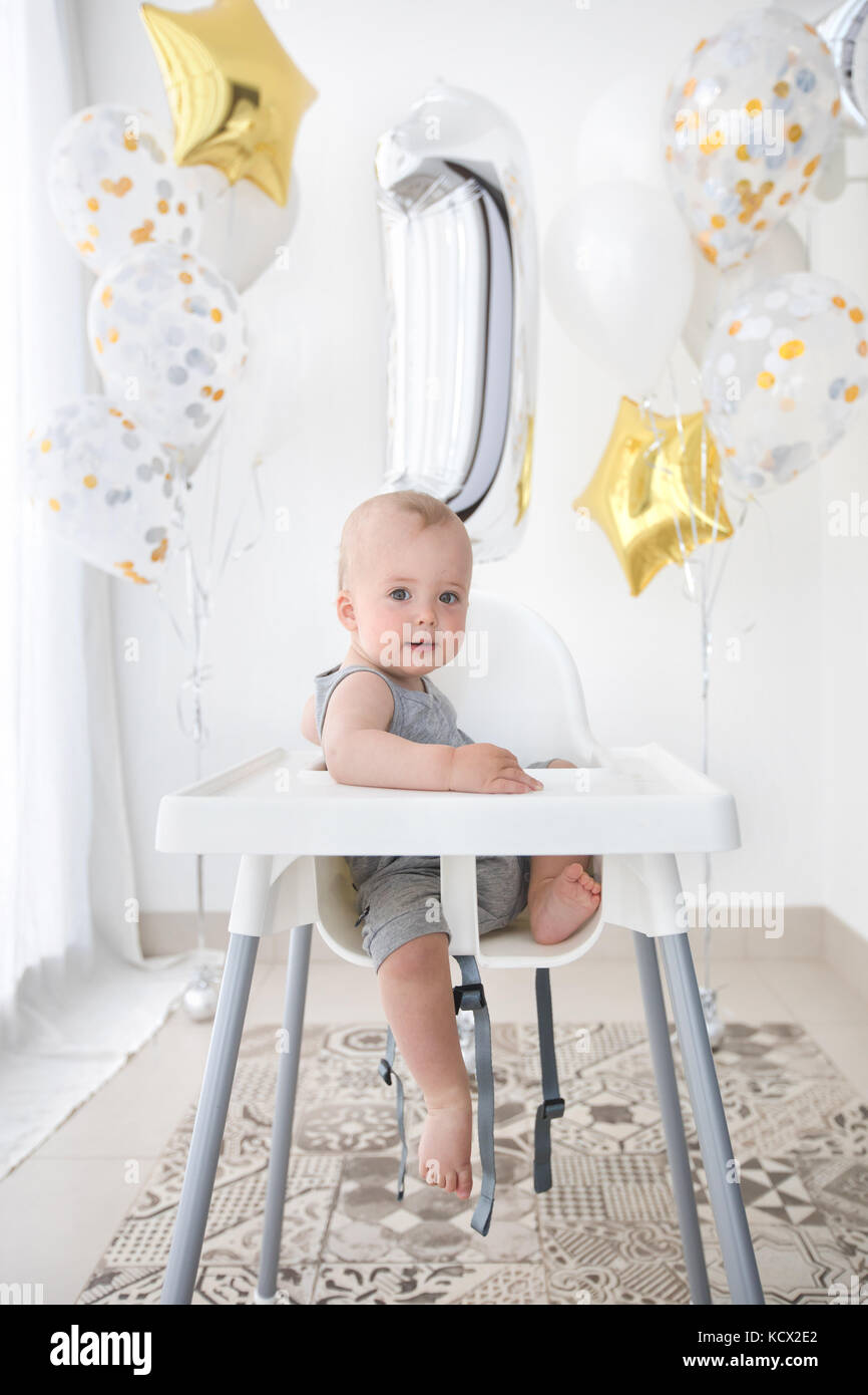 Adorable child in high chair celebrating birthday Stock Photo