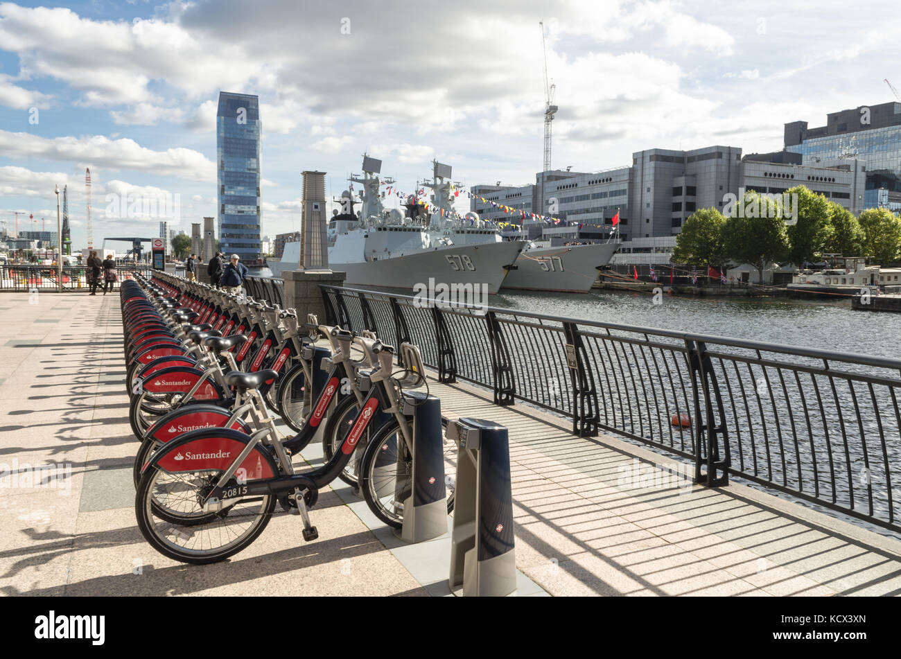 London bicycles with two Chinese warships/ frigates (The Huanggang and Yangzhou) on the West India Dock as part of a goodwill tour of European ports Stock Photo