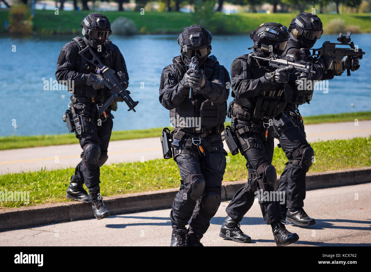 Special forces tactical team of four in action, unmarked and unrecognizable swat team Stock Photo