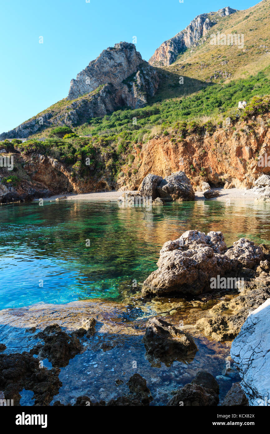 Paradise sea bay with azure water and beach. View from coastline trail of Zingaro Nature Reserve Park, between San Vito lo Capo and Scopello, Trapani  Stock Photo