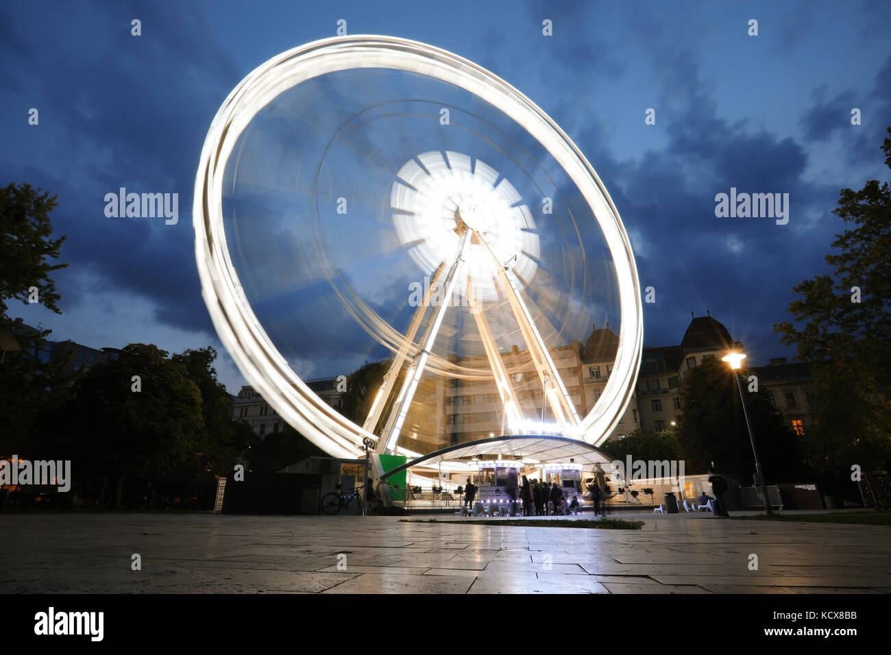 Luminous Ferris wheel in night city. Budapest Eye at night. Sziget Eye. Stock Photo