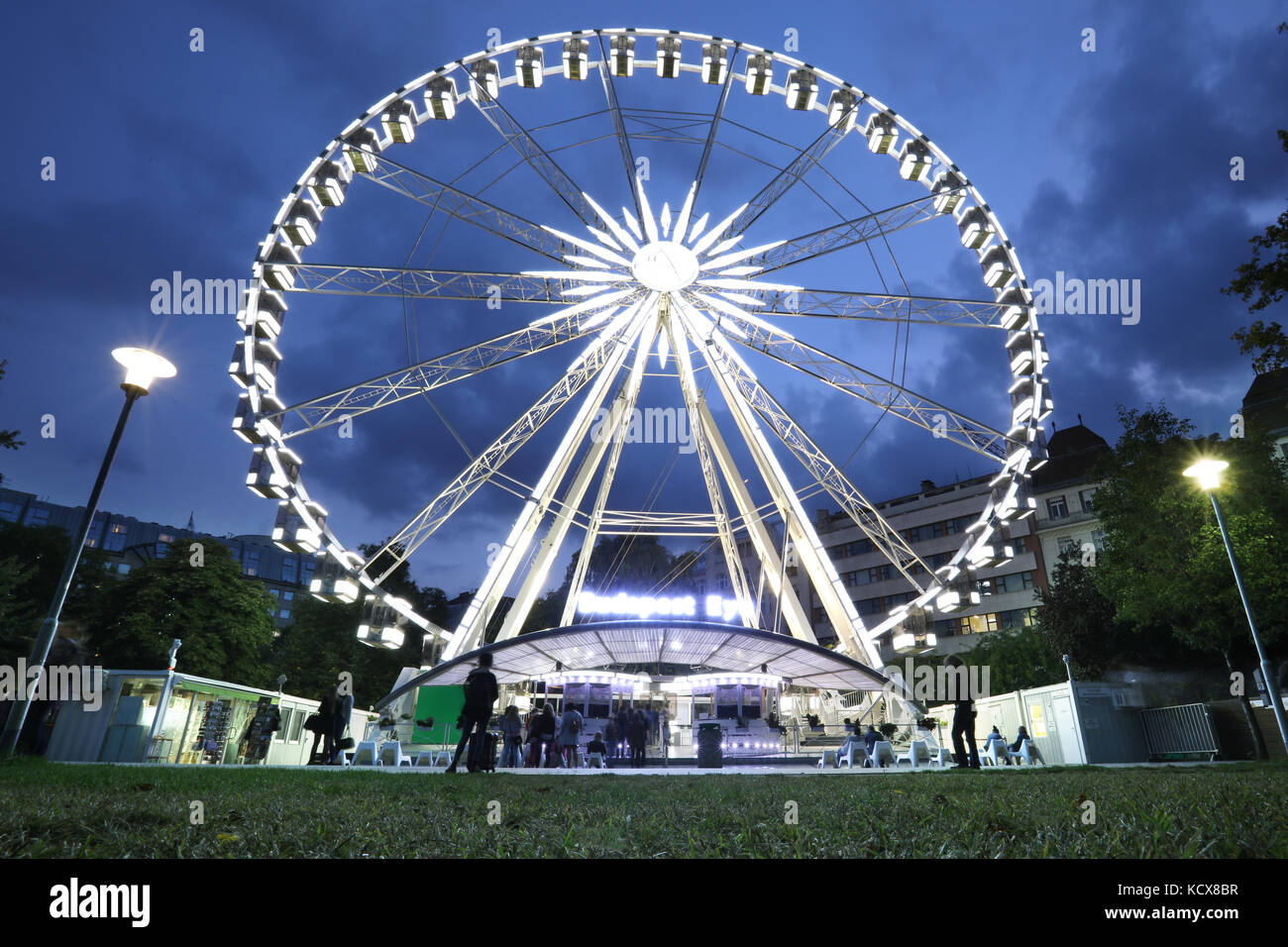 Luminous Ferris wheel in night city. Budapest Eye at night. Sziget Eye. Stock Photo