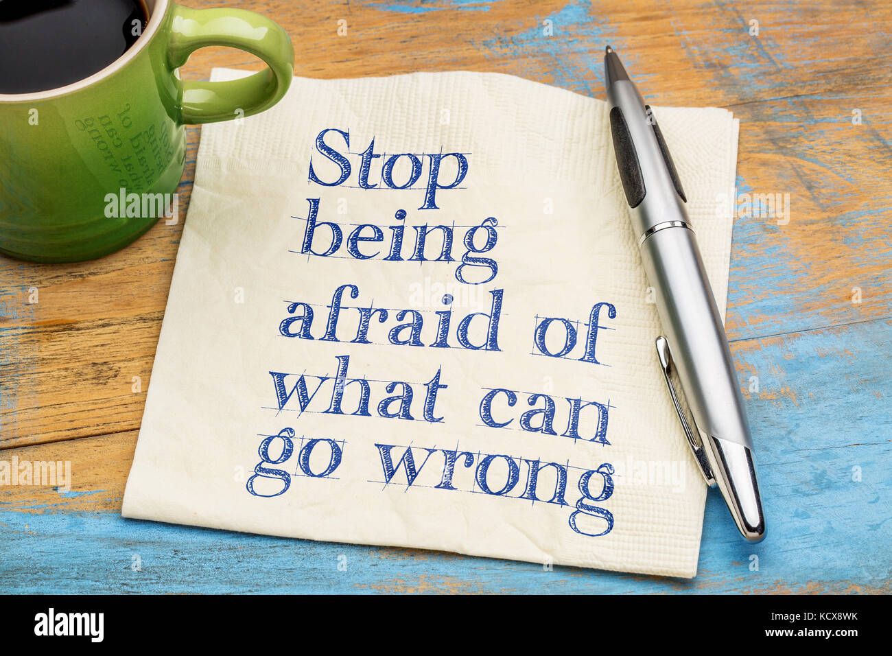 Stop being afraid of what can go wrong handwriting on a napkin with a