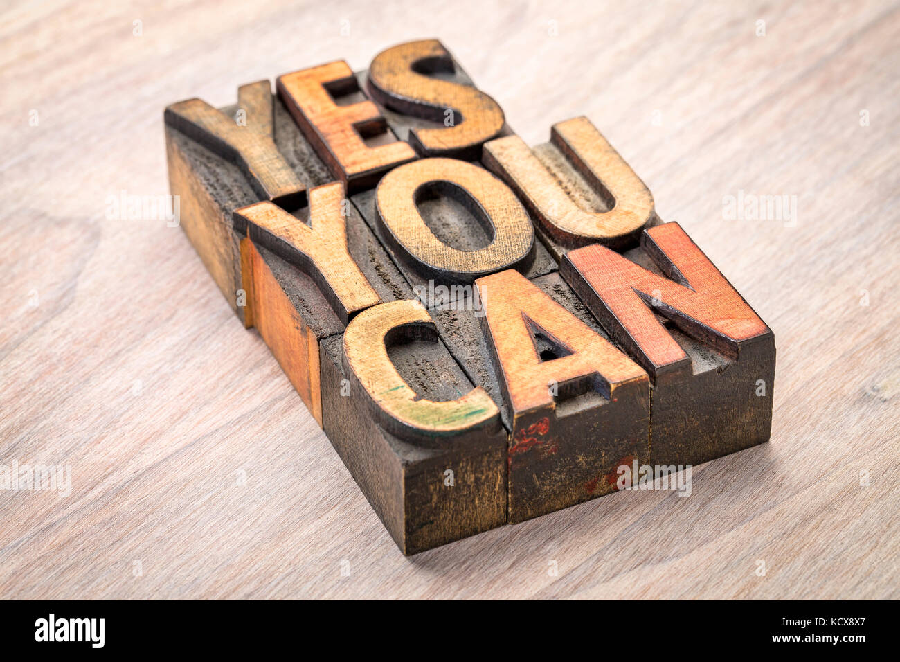 yes, you can - motivational quote abstract in vintage letterpress wood type blocks Stock Photo
