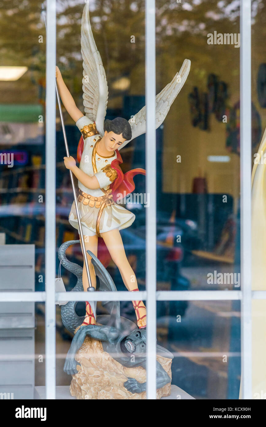 St Michael and the Archangel statue in Catholic store window Stock Photo