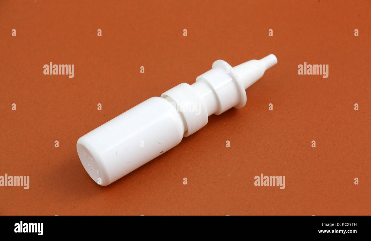 picture of a medicine spray bottle nasal , brown background Stock Photo