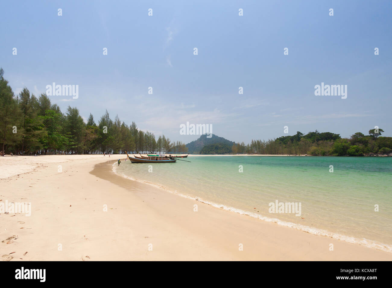 Tropical white sand beach with traditional thai longtail boat . Stock Photo