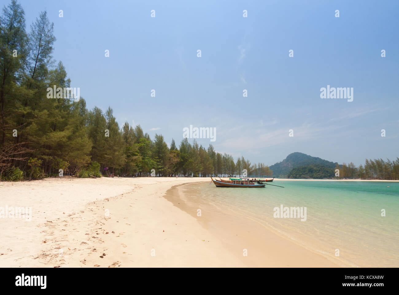 Tropical white sand beach with traditional thai longtail boat . Stock Photo