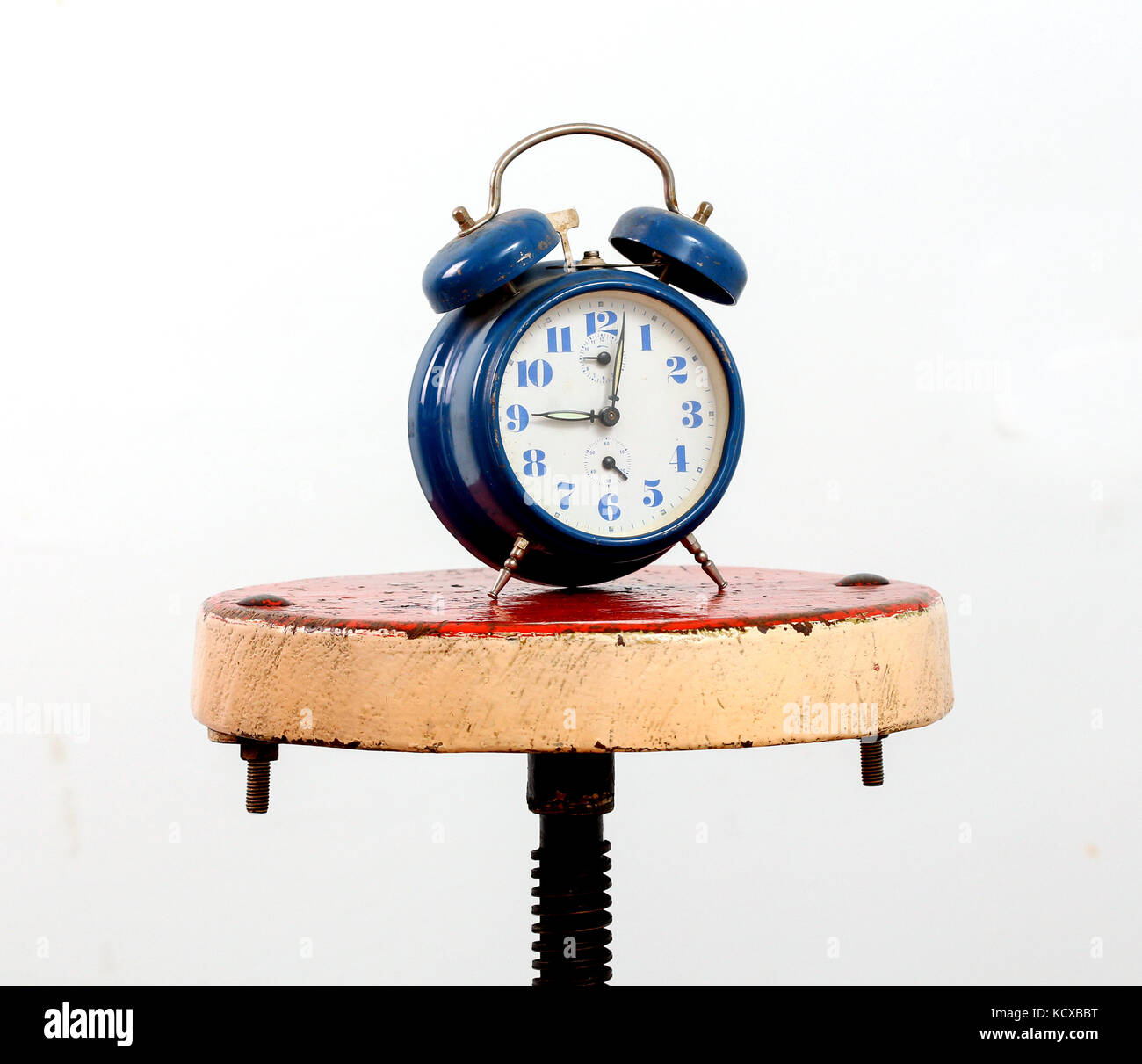 picture of a blue alarm clock on a white background Stock Photo - Alamy
