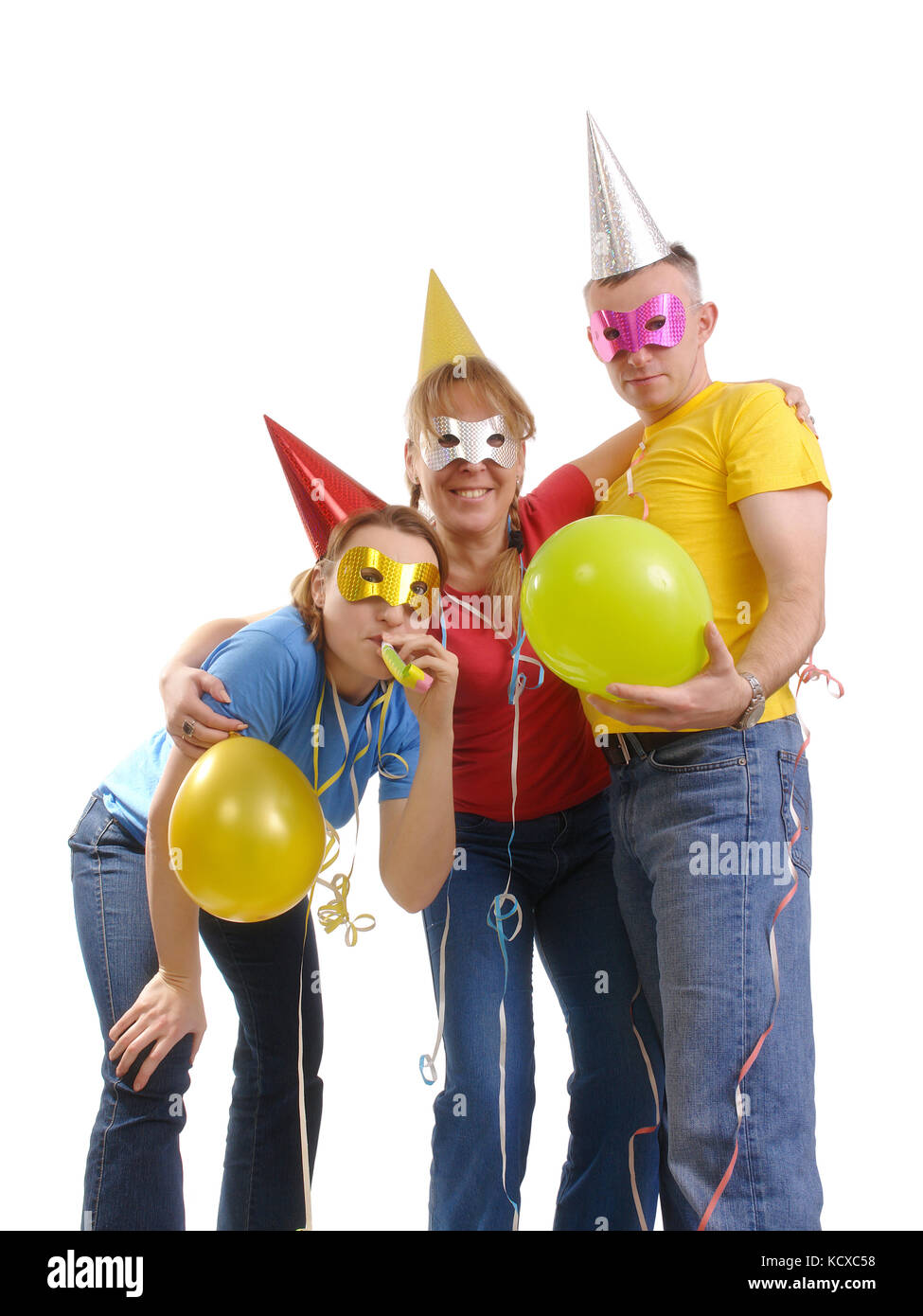Young party group wearing carnival masks and hats playing with balloons and pipes over white Stock Photo
