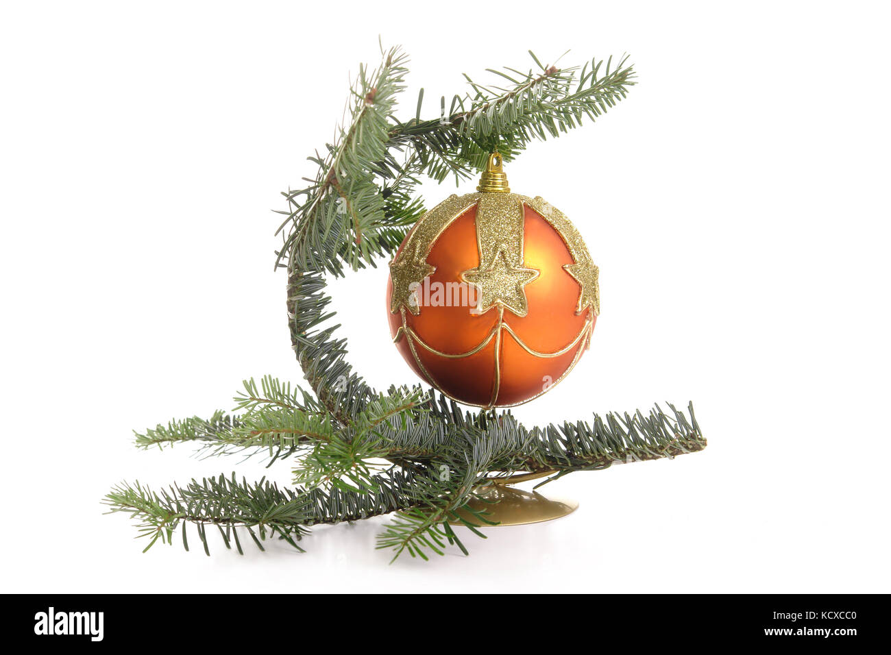 Christmas ball hanging on stand made from bent fir branch over white background Stock Photo