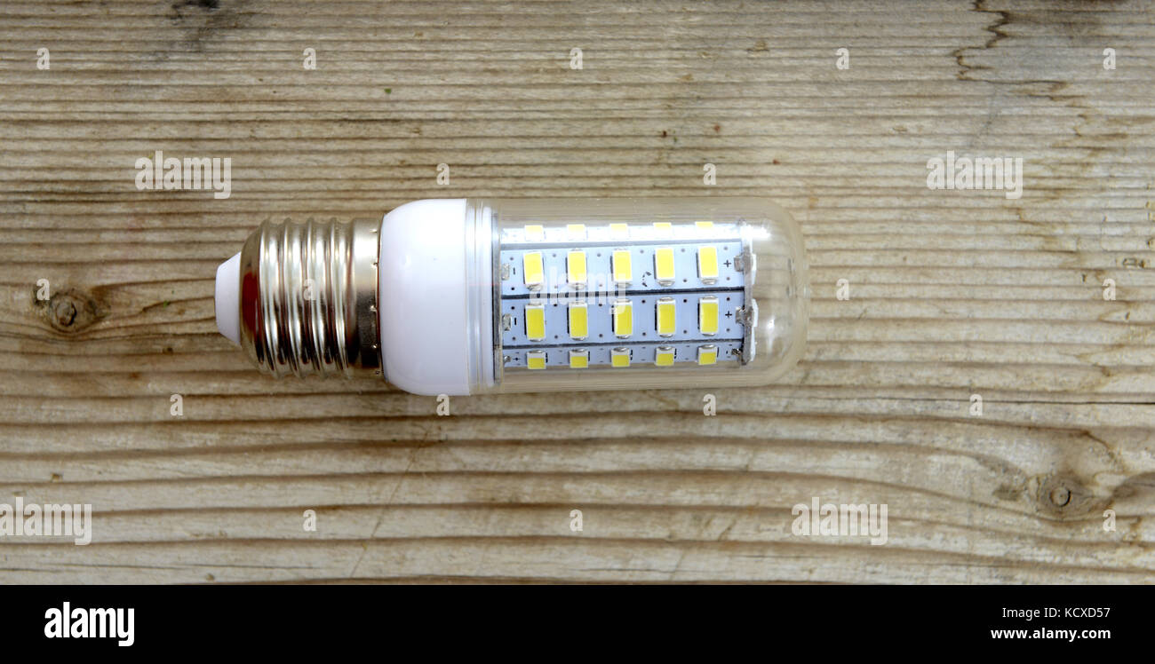 Energy saving LED light bulb on a wood background Stock Photo - Alamy