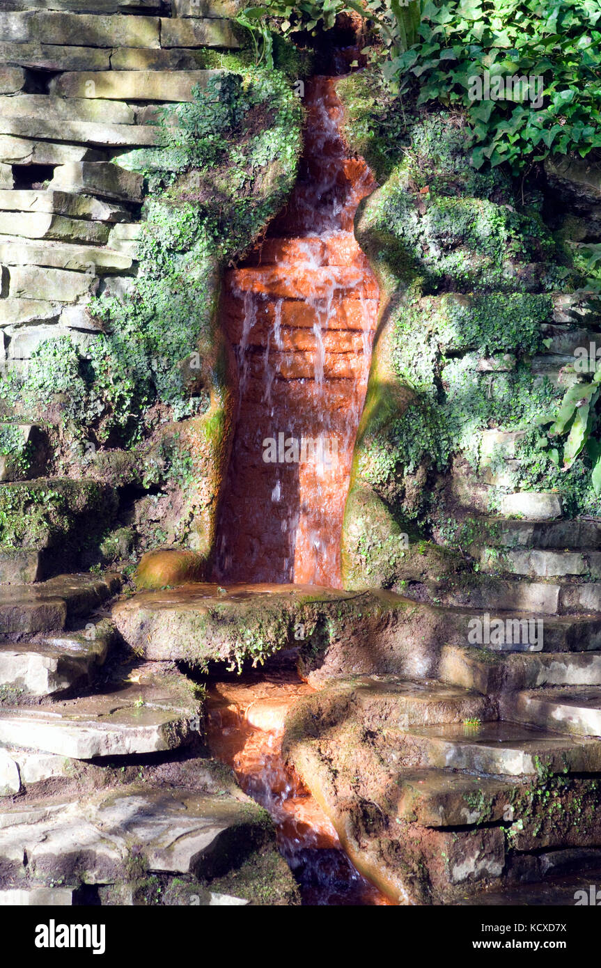 Red Spring water falling Chalice Well Gardens Glastonbury Stock Photo