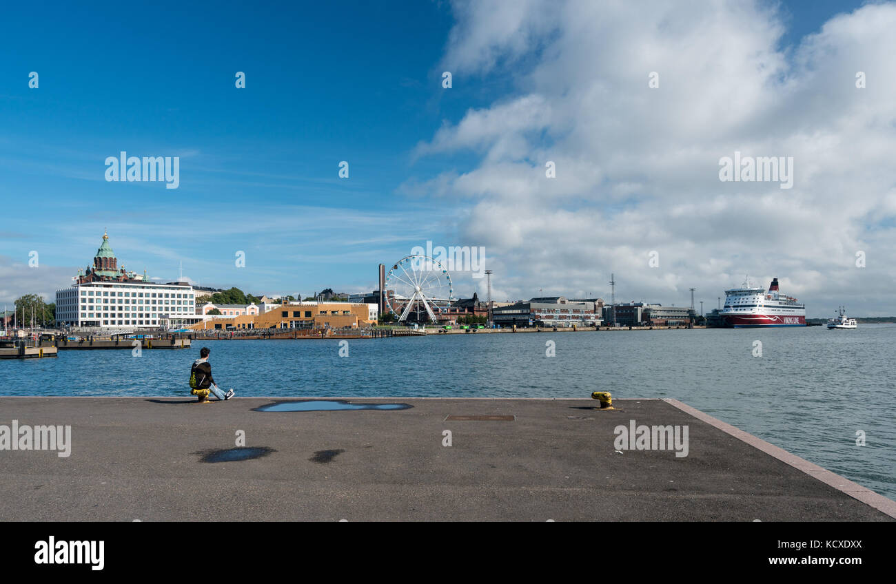 Tourist looks at the waterfront of Helsinki Harbor in Finland Stock Photo