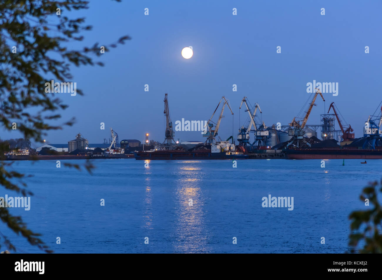 The river port at night. Loading. Specialized equipment. cranes River Stock Photo