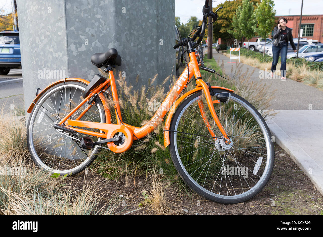 Seattle, Washington: Spin bike parked in the Fremont neighborhood. Three bicycle-sharing companies launched in Seattle this summer after the closing o Stock Photo