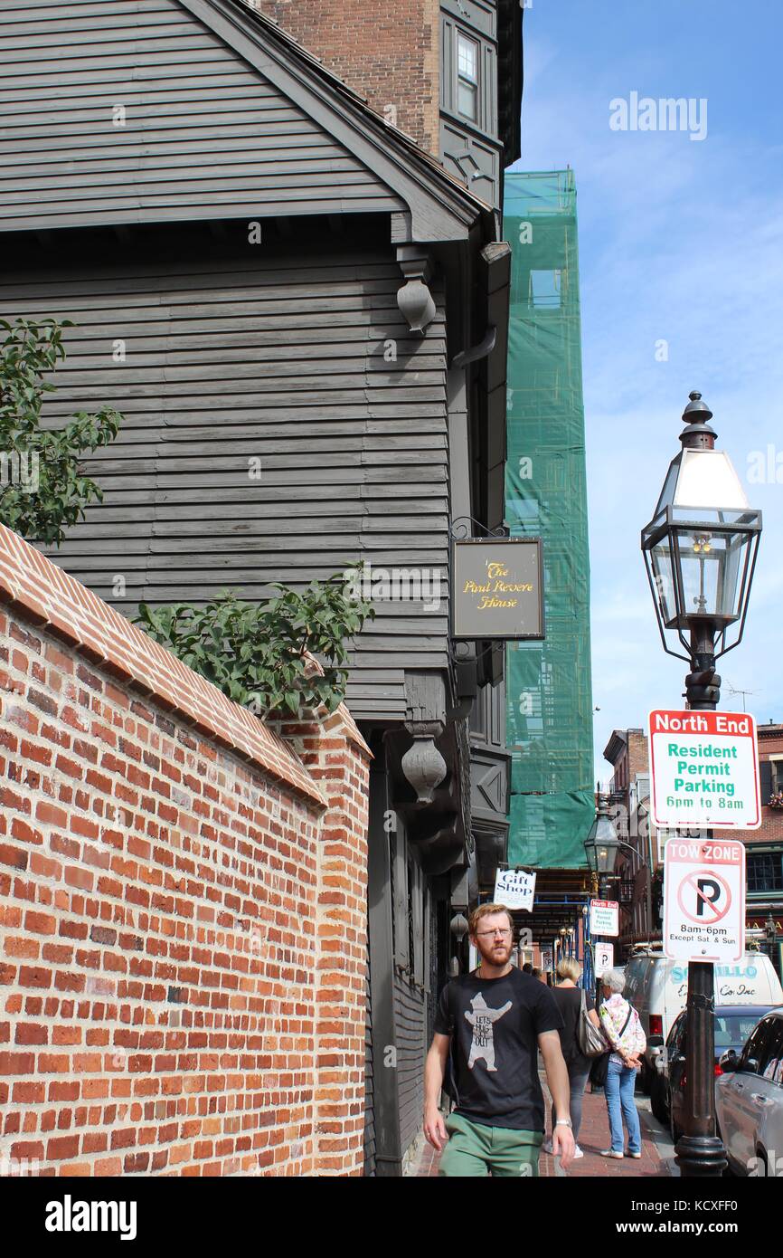 A man enjoys busy downtown Boston walking by the historic Paul Revere home Stock Photo