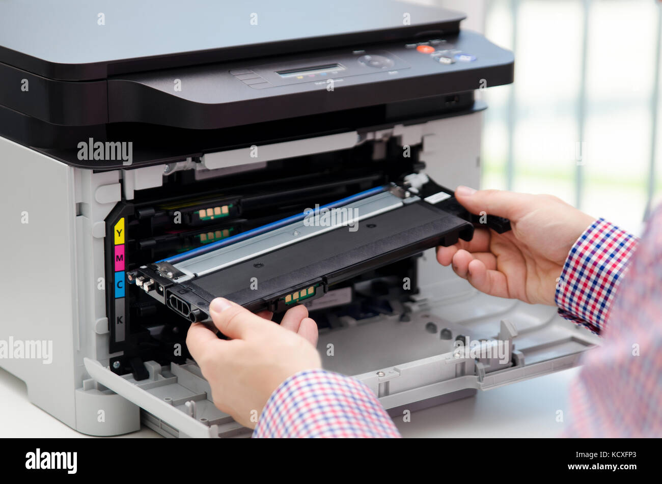 Man replacing toner in laser printer. toner printer cartridge print