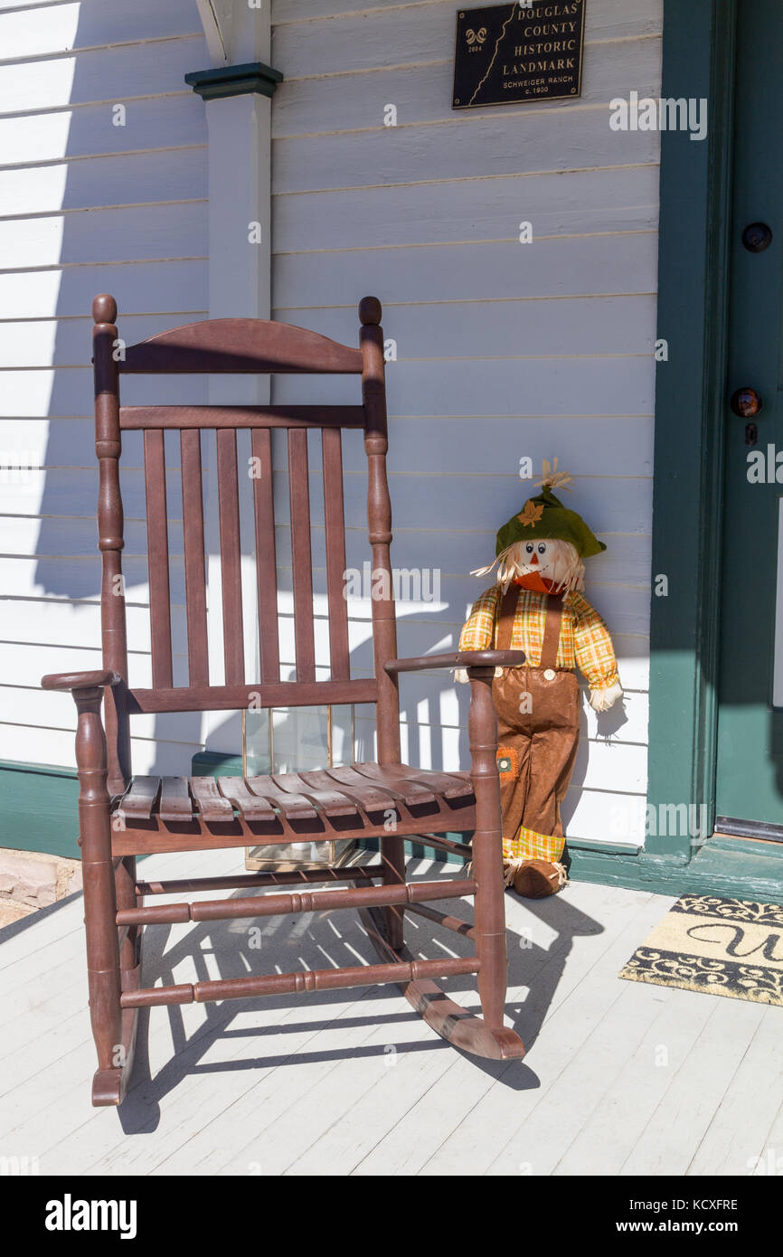 Rocking chair on the front porch of a historic homestead at the Schweiger Ranch Fall Festival, Lone Tree, Colorado, USA. Stock Photo