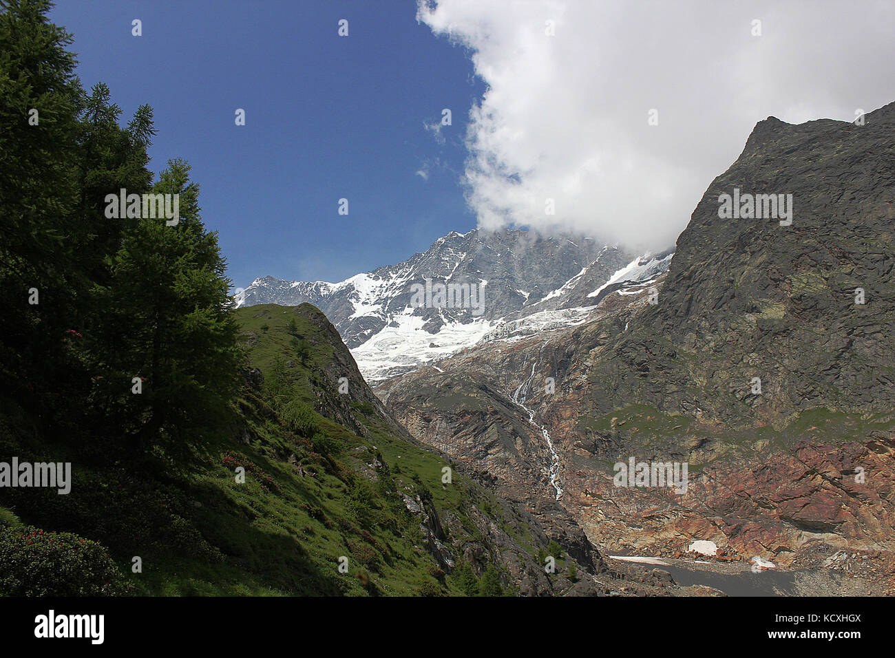 Dom and the surrounding mountains of Saas Fee and the Alpine meadows in Valais, Switzerland. Stock Photo