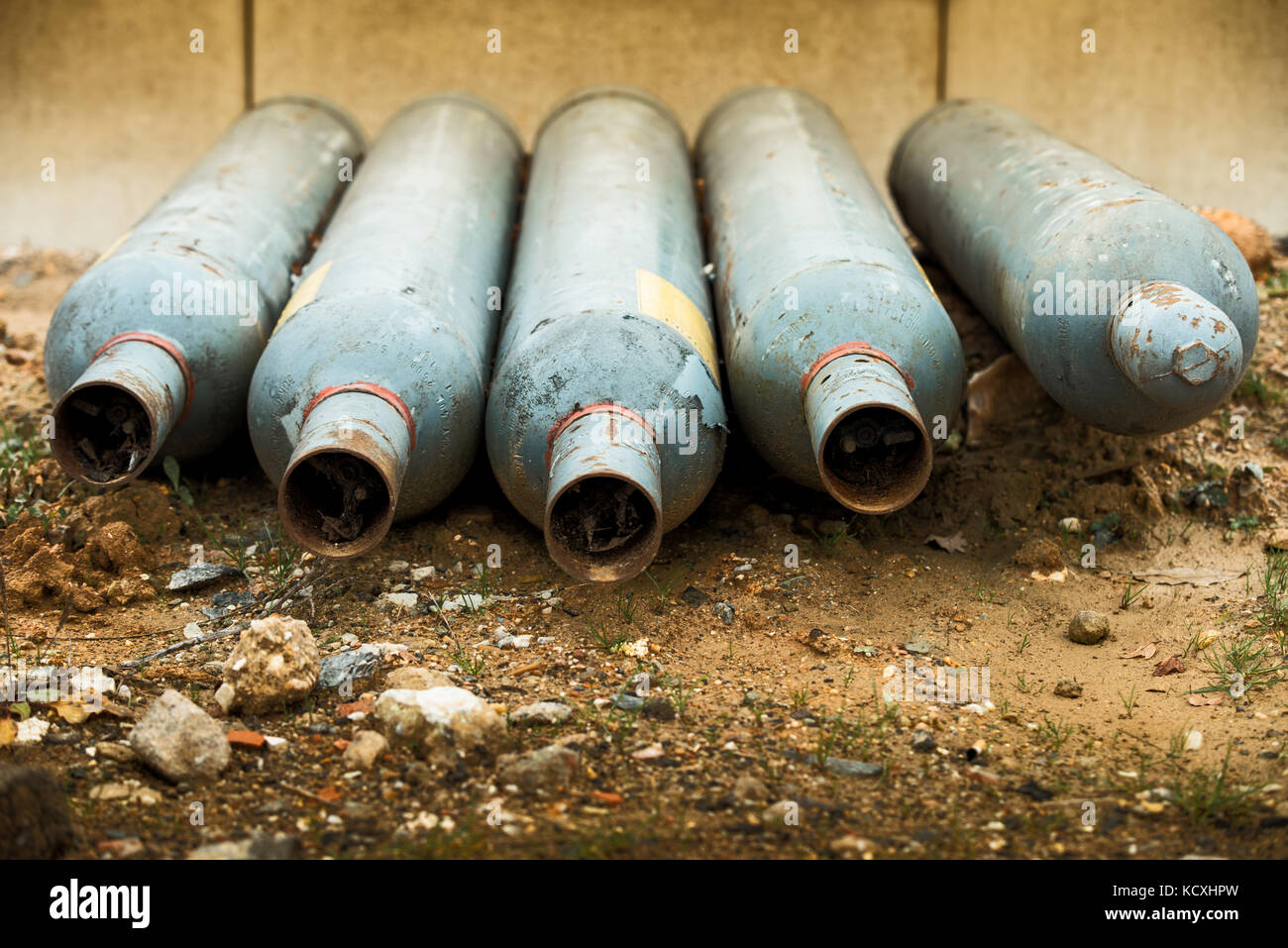 Five empty gas bottles laying on ground Stock Photo Alamy