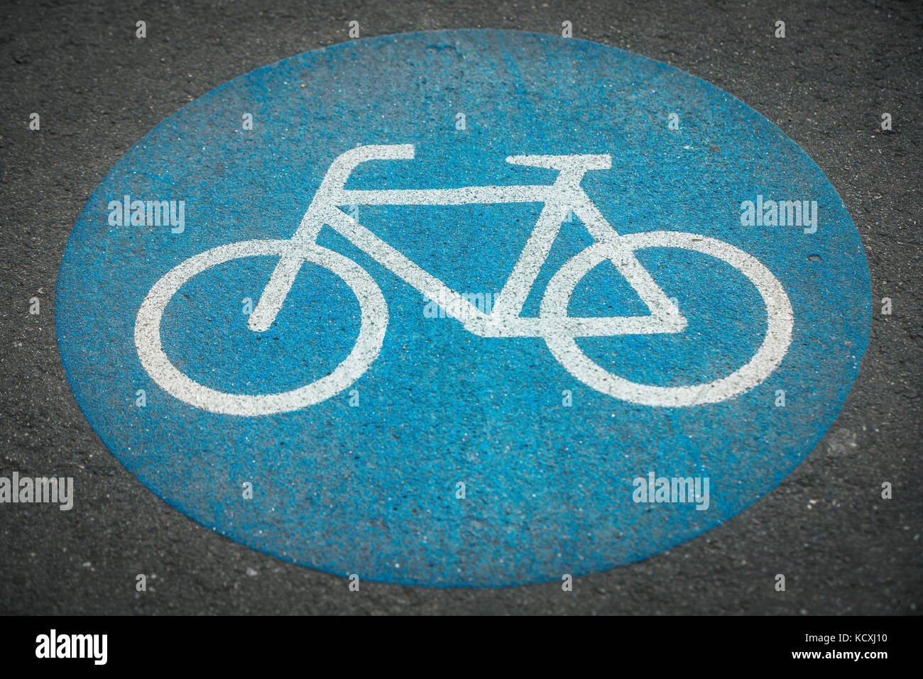 one blue bycicle sign on pavement Stock Photo - Alamy