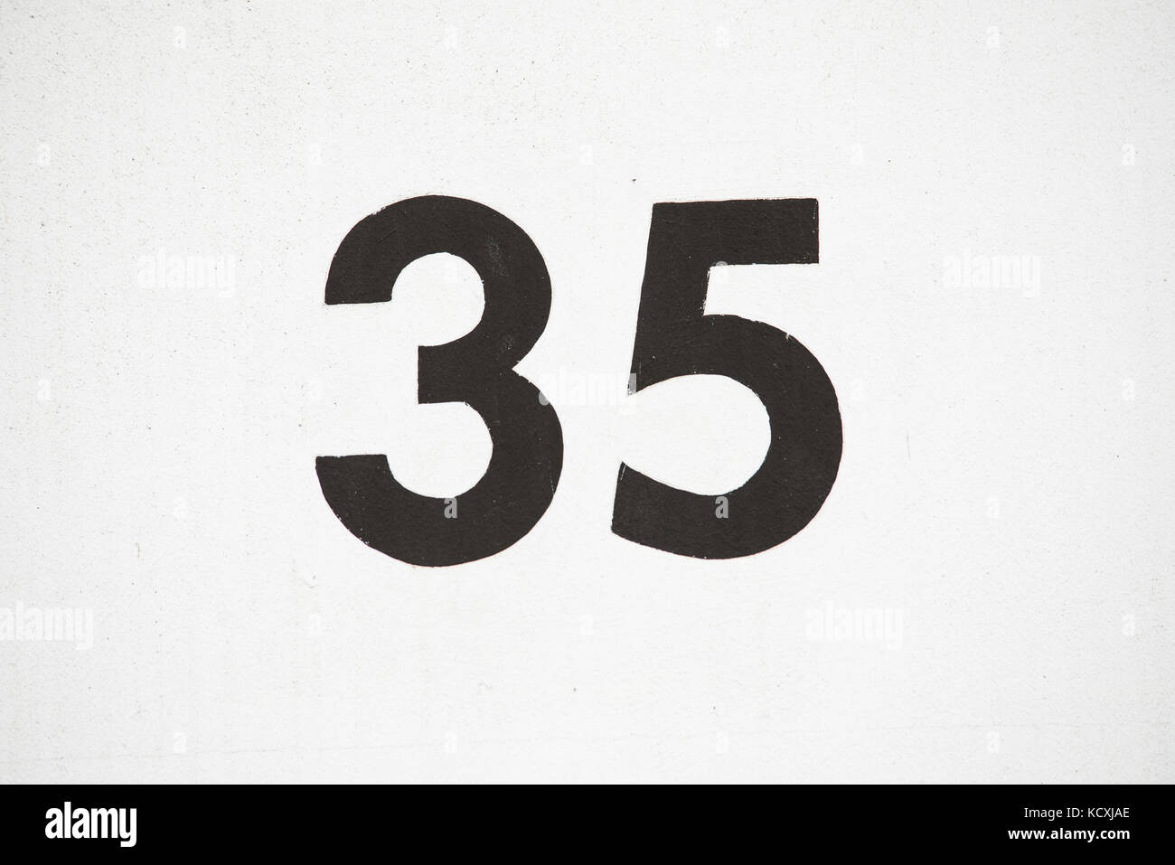 Number 35 thirtyfive painted on a white wall Stock Photo