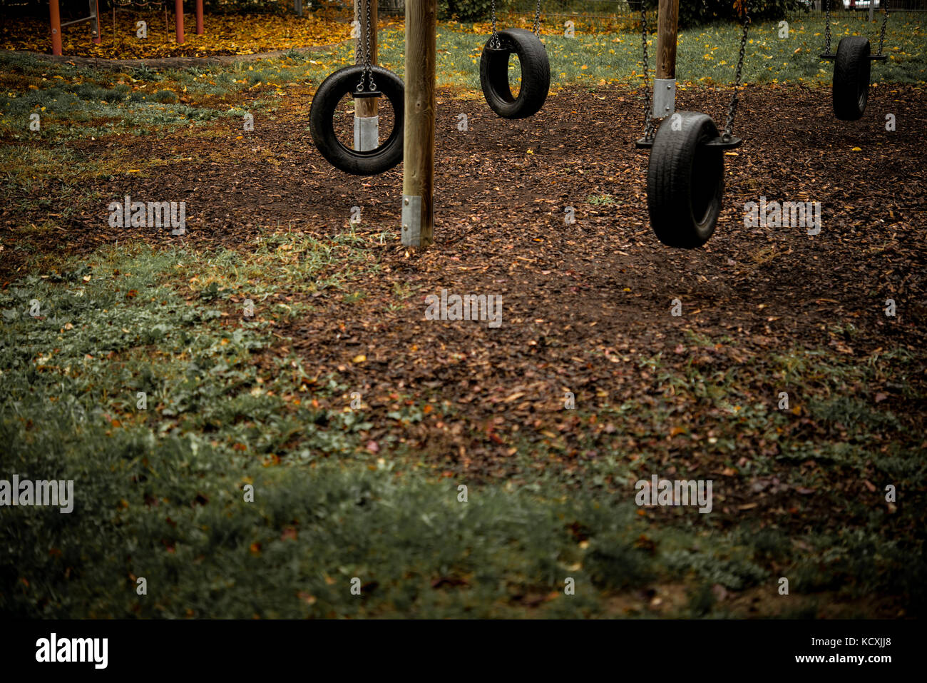 abandoned playground tire swings lonely day in autumn Stock Photo