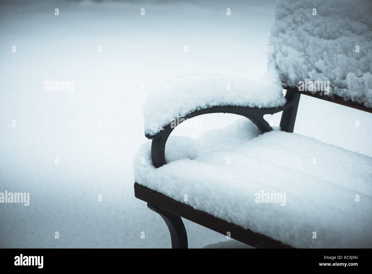 Bench in park in winter covered with snow Stock Photo - Alamy