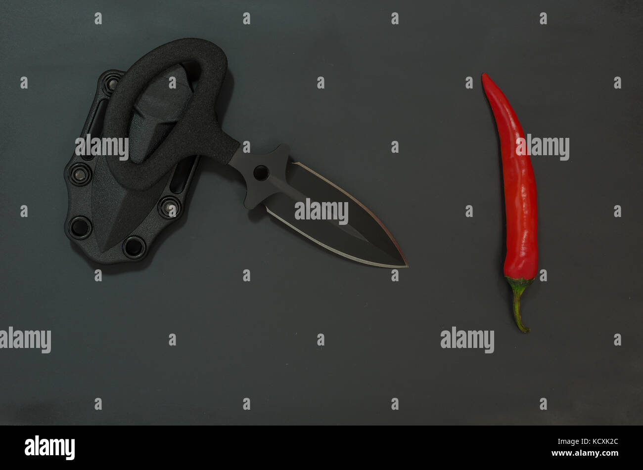 Sharp knife and chili pepper. Diagonal composition Stock Photo Alamy