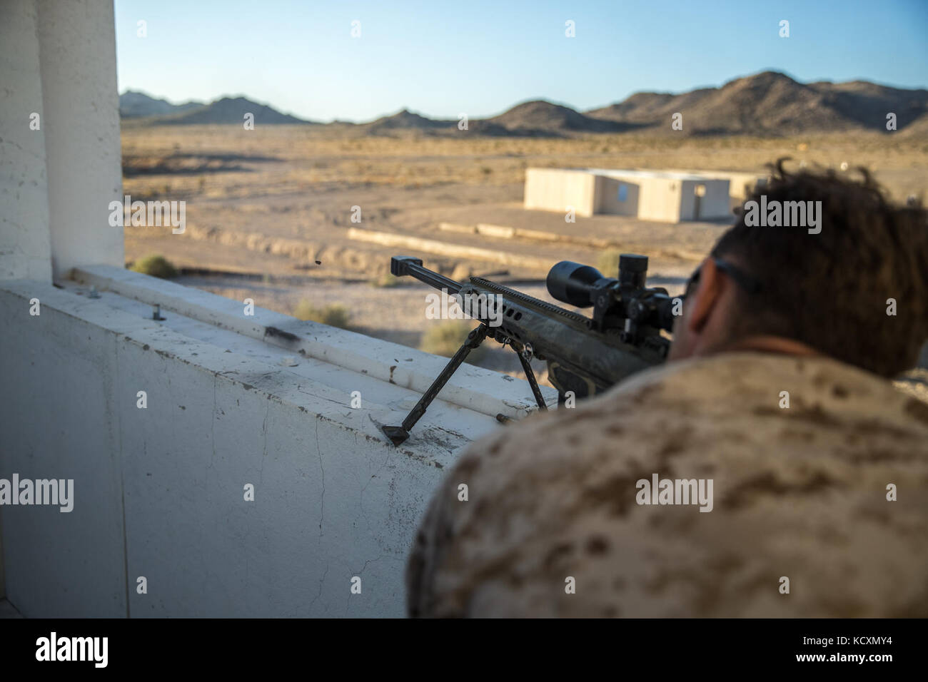 U.S. Marine Corps Cpl. Logan Clarke, a gunman with Regimental Surveillance and Target Acquisition Company (RSTAC), 1st Marine Division, fires the .50 caliber sniper rifle during a live fire drill at Fort Irwin, Calif., Oct. 3, 2017. RSTAC is an experimental company designed to build proficiency in scout sniper operations for service level exercises. (U.S. Marine Corps photo by Lance Cpl. Alexa M. Hernandez) Stock Photo